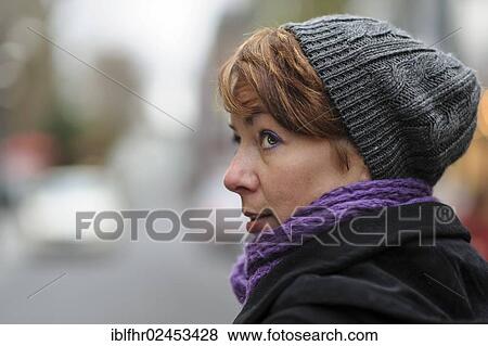 Stock Photo - "Portrait of a young woman wearing a hat and a scarf, Grevenbroich, North Rhine-Westphalia, Germany, Europe". Fotosearch