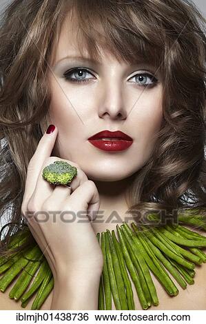 "Portrait of a young woman with green beans as a necklace and a ring of broccoli, jewelry" View Large Photo Image Stock Photograph - "Portrait of a young woman with green beans as a necklace and a ring of broccoli, jewelry". Fotosearch