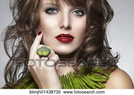 "Portrait of a young woman with green beans as a necklace and a ring of broccoli, jewelry" View Large Photo Image Stock Photography - "Portrait of a young woman with green beans as a necklace and a ring of broccoli, jewelry". Fotosearch