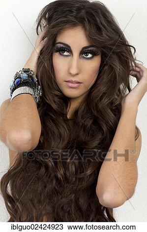 Portrait of a young woman with long hair View Large Photo Image Stock Image - Portrait of a young woman with long hair. Fotosearch