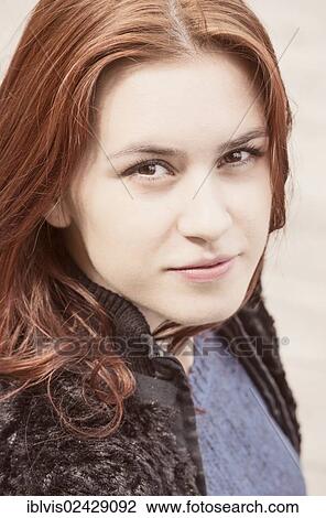 Portrait of a young woman with red hair View Large Photo Image Stock Image - Portrait of a young woman with red hair. Fotosearch