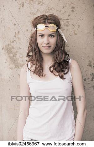 Stock Photo - Portrait of a young woman with swimming goggles on her head. Fotosearch