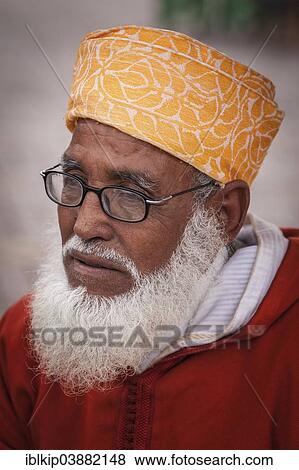 Stock Photo - "Portrait of an elderly man with glasses and white beard, wearing traditional turban, Marrakesh, Morocco, Africa". Fotosearch