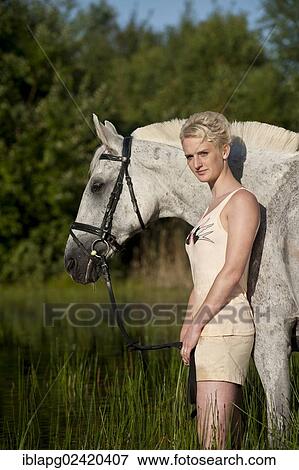 Portrait, young woman beside a Hanoverian horse View Large Photo Image Stock Photo - Portrait, young woman beside a Hanoverian horse. Fotosearch