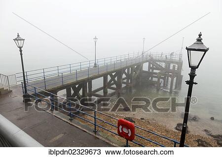 Portsmouth pier / jetty with street lamps and life preserver in fog View Large Photo Image Stock Image - Portsmouth pier / jetty with street lamps and life preserver in fog. Fotosearch