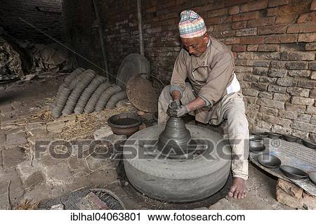 "Pottery, potter working at a potter's wheel, production of earthenware goods, Bhaktapur, Nepal, Asia" View Large Photo Image Stock Image - "Pottery, potter working at a potter's wheel, production of earthenware goods, Bhaktapur, Nepal, Asia". Fotosearch