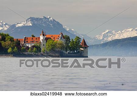 Stock Photo - Powder Tower on the western shore of Lindau, with snow-capped mountain peaks at the rear, Lindau, Bavaria, Germany, Europe, PublicGround, Europe. Fotosearch