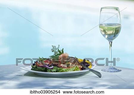 Picture - Prawn salad served with wine glass. Fotosearch