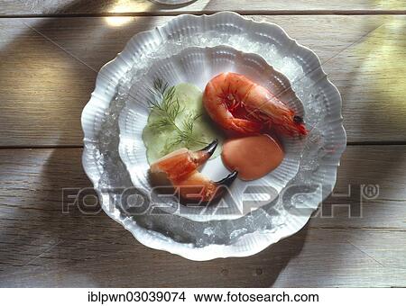 Prawns in their shell with crab claws and cucumber on white plate View Large Photo Image Picture - Prawns in their shell with crab claws and cucumber on white plate. Fotosearch