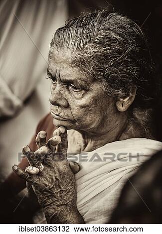 Stock Image - "Praying woman at Hindu temple festival, Thrissur, Kerala, South India, India, Asia". Fotosearch