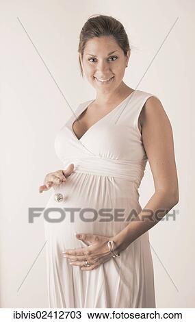 Pregnant woman holding hand with miniature disco ball on her stomach View Large Photo Image Stock Image - Pregnant woman holding hand with miniature disco ball on her stomach. Fotosearch