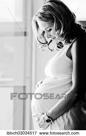 "Pregnant woman looks at her baby bump, Austria, Europe" View Large Photo Image Stock Photo - "Pregnant woman looks at her baby bump, Austria, Europe". Fotosearch