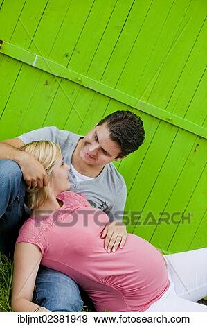 Pregnant woman lying in the arms of her husband View Large Photo Image Stock Photo - Pregnant woman lying in the arms of her husband. Fotosearch