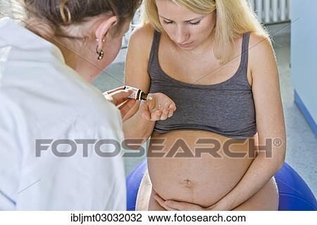 "Pregnant woman recieving homeopathic medicine from her midwife during delivery, Germany, Europe" View Large Photo Image Stock Image - "Pregnant woman recieving homeopathic medicine from her midwife during delivery, Germany, Europe". Fotosearch
