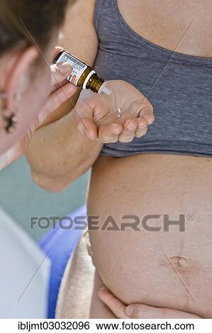 "Pregnant woman recieving homeopathic medicine from her midwife during delivery, Germany, Europe" View Large Photo Image Stock Photograph - "Pregnant woman recieving homeopathic medicine from her midwife during delivery, Germany, Europe". Fotosearch