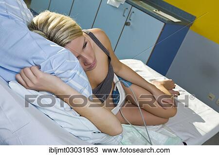 "Pregnant woman resting on a delivery bed during childbirth connected to a cardiotocography or CTG, Germany, Europe" View Large Photo Image Stock Image - "Pregnant woman resting on a delivery bed during childbirth connected to a cardiotocography or CTG, Germany, Europe". Fotosearch