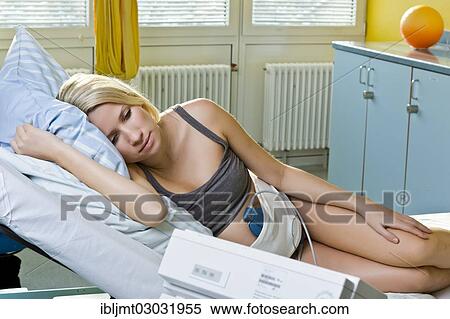Stock Photography - "Pregnant woman resting on a delivery bed during childbirth connected to a cardiotocography or CTG, Germany, Europe". Fotosearch