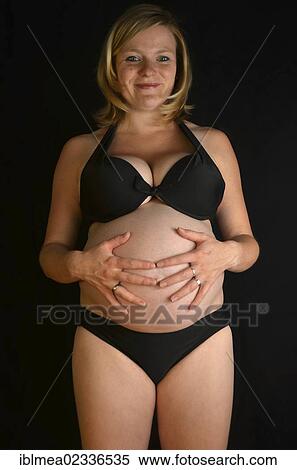 "Pregnant woman stroking her pregnant belly, 9 months" View Large Photo Image Stock Photography - "Pregnant woman stroking her pregnant belly, 9 months". Fotosearch