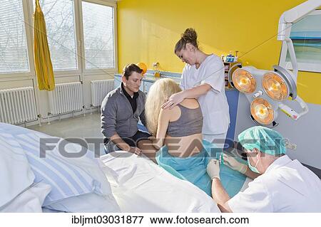 "Pregnant women during delivery in the delivery room with an anesthesiologist applying a PDA or epidural, Germany, Europe" View Large Photo Image Stock Photo - "Pregnant women during delivery in the delivery room with an anesthesiologist applying a PDA or epidural, Germany, Europe". Fotosearch