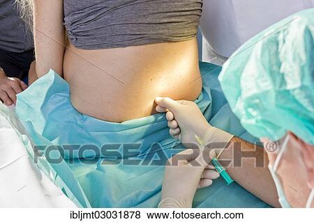 "Pregnant women during delivery in the delivery room with an anesthesiologist applying a PDA or epidural, Germany, Europe" View Large Photo Image Stock Photo - "Pregnant women during delivery in the delivery room with an anesthesiologist applying a PDA or epidural, Germany, Europe". Fotosearch