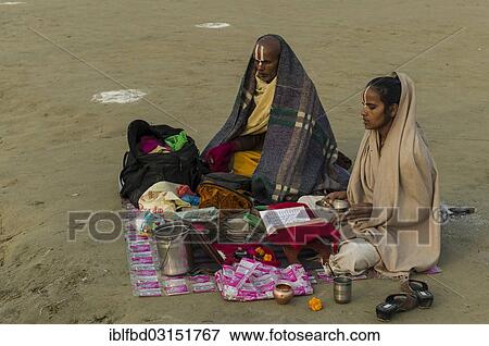 Stock Photo - "Priest and his daughter meditating, during Kumbha Mela, Allahabad, Uttar Pradesh, India, Asia". Fotosearch