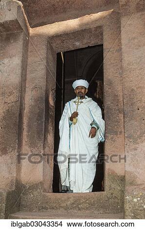 "Priest holding a cross, at the monolithic rock-cut Church of Bete Giyorgis, Saint George, Lalibela, Amhara Region, Ethiopia, Africa" View Large Photo Image Picture - "Priest holding a cross, at the monolithic rock-cut Church of Bete Giyorgis, Saint George, Lalibela, Amhara Region, Ethiopia, Africa". Fotosearch