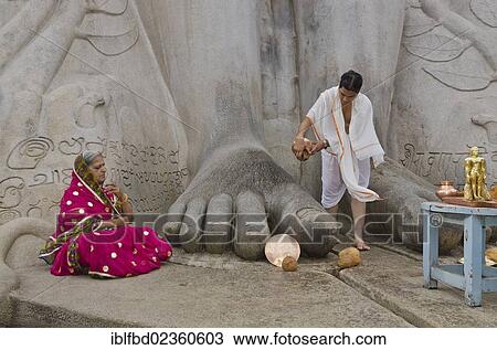 "Priest is pouring water on the feet of the gigantic statue of Gomateshwara in Sravanabelagola, pilgrim meditating, Sravanabelagola, India, Asia" View Large Photo Image Stock Image - "Priest is pouring water on the feet of the gigantic statue of Gomateshwara in Sravanabelagola, pilgrim meditating, Sravanabelagola, India, Asia". Fotosearch