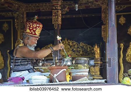 Stock Image - "Priests celebrating Mass, Temple of the Bats or Goa Lawah, Bali, Indonesia, Asia". Fotosearch