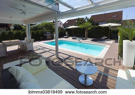 "Private house with a conservatory, a lounge, a pool and a terrace, Germany, Europe" View Large Photo Image Stock Photo - "Private house with a conservatory, a lounge, a pool and a terrace, Germany, Europe". Fotosearch