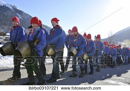 Stock Image - "Procession of school boys with large bells on 1st March, Chalandamarz, Engadine spring ritual, Zernez, Unterengadin, Engadin, Canton of Graubunden, Switzerland, Europe". Fotosearch