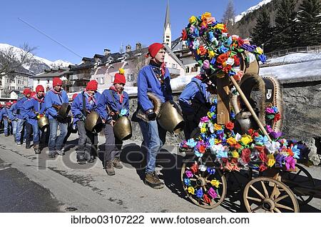Stock Image - "Procession of school boys with large bells on 1st March, Chalandamarz, Engadine spring ritual, Zernez, Unterengadin, Engadin, Canton of Graubunden, Switzerland, Europe". Fotosearch