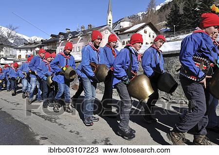 Stock Image - "Procession of school boys with large bells on 1st March, Chalandamarz, Engadine spring ritual, Zernez, Unterengadin, Engadin, Canton of Graubunden, Switzerland, Europe". Fotosearch