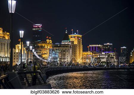 Stock Photograph - "Promenade at the Huangpu River at night, at the back neo-classical buildings, the Bank of China, City Hall, the Peace Hotel, The Bund, Shanghai, China, Asia". Fotosearch