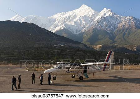 "Propeller aircraft DHC-6 Twin Otter at Jomsom airport, behind the snow-capped mountain Nilgiri North, Lower Mustang, Nepal, Asia" View Large Photo Image Stock Photo - "Propeller aircraft DHC-6 Twin Otter at Jomsom airport, behind the snow-capped mountain Nilgiri North, Lower Mustang, Nepal, Asia". Fotosearch