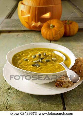 Pumpkin and bacon soup with a traditional Halloween pumpkin with a carved face View Large Photo Image Stock Image - Pumpkin and bacon soup with a traditional Halloween pumpkin with a carved face. Fotosearch