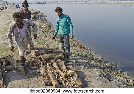 Picture - "Putting a dead body on firewood on the banks of river Yamuna as part of a cremation ceremony, Vrindavan, India, Asia". Fotosearch