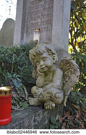 "Putto and votive candle with autumn leaves on the Ostfriedhof or East Cemetery, Munich, Bavaria, Germany, Europe" View Large Photo Image Stock Photograph - "Putto and votive candle with autumn leaves on the Ostfriedhof or East Cemetery, Munich, Bavaria, Germany, Europe". Fotosearch