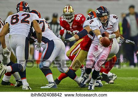 Stock Image - "QB Kyle Orton, #08 Broncos, hands off the ball during the NFL International game between the San Francisco 49ers and the Denver Broncos on October 31, 2010 in London, England, United Kingdom, Europe". Fotosearch