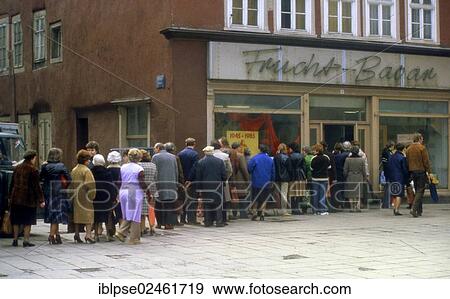 "Queue in front of a grocery store, Frucht-Basar fruit bazaar, Erfurt, in April 1985, in the window is a propaganda poster for the 40th anniversary of end of the war, GDR, German Democratic Republic, Europe" View Large Photo Image Stock Photo - "Queue in front of a grocery store, Frucht-Basar fruit bazaar, Erfurt, in April 1985, in the window is a propaganda poster for the 40th anniversary of end of the war, GDR, German Democratic Republic, Europe". Fotosearch