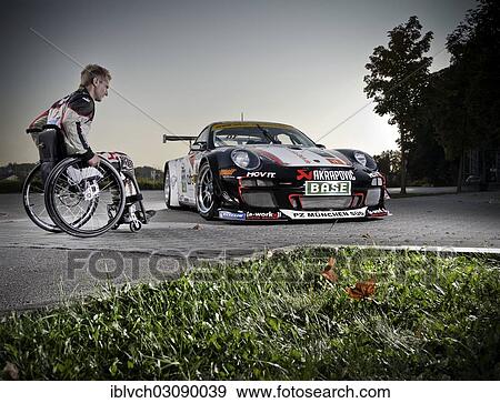"Race car driver in a wheelchair, next to his Porsche race car, Munich, Upper Bavaria, Bavaria, Germany, Europe" View Large Photo Image Stock Photo - "Race car driver in a wheelchair, next to his Porsche race car, Munich, Upper Bavaria, Bavaria, Germany, Europe". Fotosearch