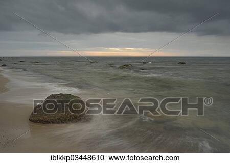 "Rain front, dramatic cloudy sky at sunset, stones on the beach, Dranske, Mecklenburg-Western Pomerania, Germany, Europe" View Large Photo Image Stock Image - "Rain front, dramatic cloudy sky at sunset, stones on the beach, Dranske, Mecklenburg-Western Pomerania, Germany, Europe". Fotosearch