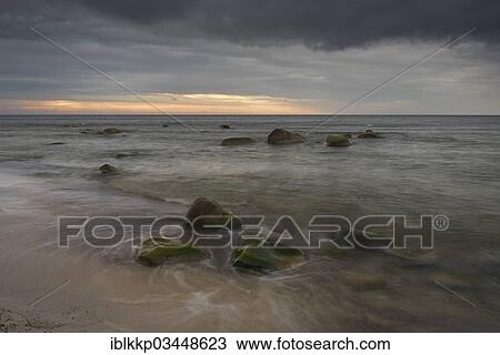 "Rain front, dramatic cloudy sky at sunset, stones on the beach, Dranske, Mecklenburg-Western Pomerania, Germany, Europe" View Large Photo Image Stock Image - "Rain front, dramatic cloudy sky at sunset, stones on the beach, Dranske, Mecklenburg-Western Pomerania, Germany, Europe". Fotosearch