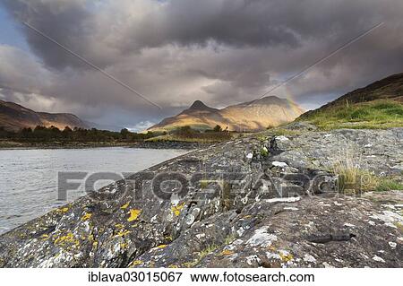 "Rainbow arching over the Pap of Glencoe or Sgorr na Ciche during unsettled weather, with granite rocks and Loch Leven at front, Loch Leven, Ballachulish, Highlands, Scotland, United Kingdom, Europe" View Large Photo Image Stock Photo - "Rainbow arching over the Pap of Glencoe or Sgorr na Ciche during unsettled weather, with granite rocks and Loch Leven at front, Loch Leven, Ballachulish, Highlands, Scotland, United Kingdom, Europe". Fotosearch