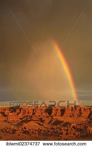 Stock Photo - "Rainbow during a thunderstorm, eroded entrada sandstone hoodoos and rock formations, Goblins, Goblin Valley State Park, San Rafael Reef Desert, Utah, Southwestern USA, USA". Fotosearch