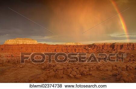 Stock Photo - "Rainbow during a thunderstorm, eroded entrada sandstone hoodoos and rock formations, Goblins, Goblin Valley State Park, San Rafael Reef Desert, Utah, Southwestern USA, USA". Fotosearch