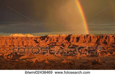 Stock Photo - "Rainbow during a thunderstorm, hoodoos and eroded rock formations of Entrada sandstone, Goblins, Goblin Valley State Park, San Rafael Reef Desert, Utah, Southwest, United States, North America". Fotosearch