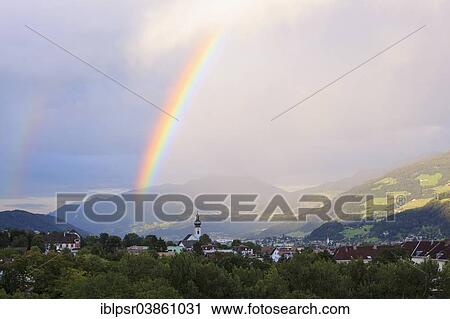 Stock Image - "Rainbow over the Inn Valley, Hall, Tyrol, Austria, Europe". Fotosearch