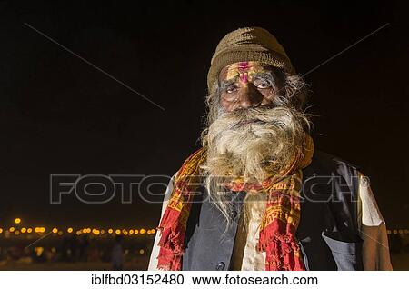 Stock Image - "Rama sadhu, holy man, at night at the Sangam, the confluence of the rivers Ganges, Yamuna and Saraswati, during Kumbha Mela festival, Allahabad, Uttar Pradesh, India, Asia". Fotosearch