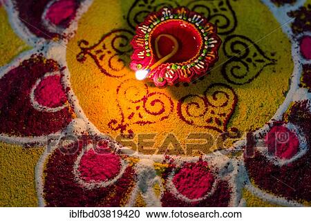 "Rangoli, an artwork made from colour powder, and an oil lamp for the festival Diwali, Mumbai, Maharashtra, India, Asia" View Large Photo Image Stock Image - "Rangoli, an artwork made from colour powder, and an oil lamp for the festival Diwali, Mumbai, Maharashtra, India, Asia". Fotosearch