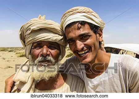 "Rashaida father and son standing in front of their tent in the desert around Massaua, Eritrea, Africa" View Large Photo Image Stock Photo - "Rashaida father and son standing in front of their tent in the desert around Massaua, Eritrea, Africa". Fotosearch